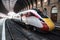 LNER Azuma train on a platform waiting to depart.  Empty Platform  inside historic Victorian Railway Station