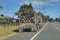 Load of harvested pine logs carried on the trucks to timber mills. New Zealand forestry industry