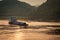 Loaded barge sails while sunset reflected by Yangtze River, Chongqing, China