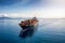 A loaded container cargo vessel traveling over calm, blue sea