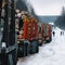 Loaded long vehicles on winter road among forest