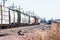 Loaded railroad cars on a siding waiting to be hauled west