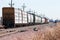 Loaded railroad cars on a siding waiting to be hauled west