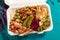 Loaded sharing portion of traditional Mediterranean Arabic food of hummus, olives, grilled chicken, halloumi, dolma, couscous,