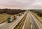 Loaded timber trucks transport timber logs with an overload on the highway