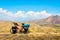 Loaded touring bicycle stands with moody dramatic panoramic mountains view and no cyclist