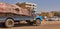 Loaded truck with torn tarpaulin on a road n suburb of Khartoum