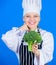 Loaded with vitamin. Lady cook smiling with vitamin broccoli. Happy woman holding fresh green vitamin broccoli crop