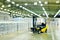 loader on the background of a huge industrial food warehouse with plastic PET bottles with beer, water, drinks.