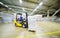 loader on the background of a huge industrial food warehouse with plastic PET bottles with beer, water, drinks.