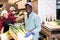 Loader dragging boxes of leeks in vegetable processing factory