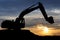 Loader excavator over sunset