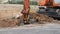 Loader Excavator working in a construction site, tilt shift effect