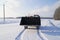 Loader with a huge bucket standing on snowy road