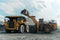 A loader loads ore into a dump truck.