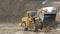 Loader machine unloading sand at construction site