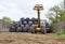 Loader tractor stacking round bales in a stack