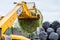 Loader tractor stacking round bales in a stack