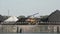 Loader trucks transporting coal in the harbor of Ghent