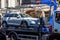 Loading a car onto a tow truck in a narrow street of the old city