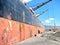 Loading cargo of cement clinker in bulk carrier vessel by ships cranes in the port of Izmir, Turkey.