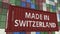 Loading container with MADE IN SWITZERLAND caption. Swiss import or export related 3D rendering