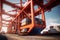 Loading a container ship at cargo berth of the seaport using port cranes. Containers are stacked and secured on board