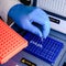 Loading a DNA tube into a PCR polymerase chain reaction thermocycler machine in a bioscience laboratory. Concept of science,