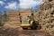 Loading logs with a special loader.Timber products warehouse on a specialized site