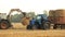 Loading round hay bales in a tracktor.