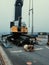 Loading steel coils from shore to the cargo vessel. Worker to slig coils for loading by shore crane. Industrial