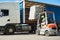 Loading works. Forklift with load and lorry truck