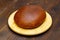 A loaf of black bread. Homemade Baked bread in the oven in one piece. Eco friendly round bread on a white cutting board, against