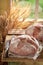 Loaf of bread with grain and ears in summer kitchen