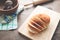 Loaf of bread on wood background with bakery tools