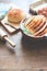 Loaf of bread on wood background with eggs and bakery tools