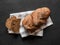 Loaf dark buckwheat bread on white textile napkin black table background. Fresh delicious homemade healthy bake. Bakery