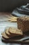 Loaf of fitness rye bread with ears of wheat on wooden board. Space for text