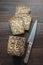 Loaf of fitness rye bread with ears of wheat on wooden board. View from above