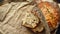 This is a loaf of fresh crusty bread with cereals on sourdough. Yeast-free homemade cakes lie on yellow craft paper.