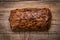 Loaf fruit bread on wooden background.