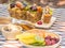 A loaf of fruit cake in wooden plate with defocused of dried fruit, spices and honey