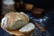 A loaf of homemade bread from whole grain flour and flax seeds on a dark wooden background. Copy space. Photographing with natural