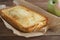 Loaf of Pie or Pound Bread on a Cutting Board. Sweet Dessert Pie, homemade pastry. Wooden table, close up. Breakfast.