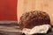 a loaf of rye bread on paper coasters and a board in the background of a wooden table