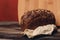 a loaf of rye bread on paper coasters and a board in the background of a wooden table