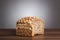 Loaf and slice of wholemeal bread on table