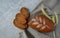 Loaf of sliced rye healthy bread, spikelets of wheat, with on an old wooden board on a gray background, copy space