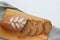 Loaf of sliced rye healthy bread, spikelets of wheat, with on an old wooden board on a gray background, copy space