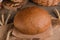 Loaf of traditional round rye bread on wooden background